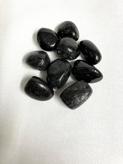 Group of Black Tourmaline Crystals on a white fabric background