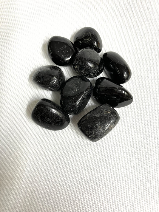 Group of Black Tourmaline Crystals on a white fabric background
