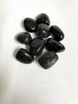 Group of Black Tourmaline Crystals on a white fabric background