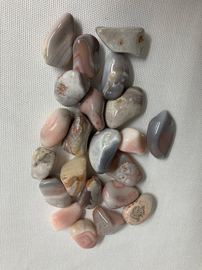 Back view of Botswana Agate Crystals on a textured gray surface