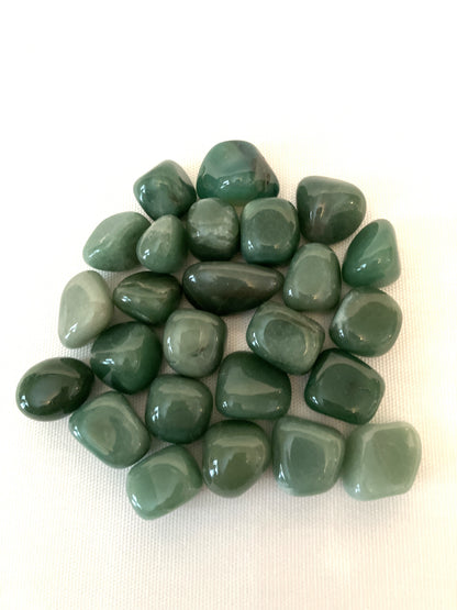 Closeup of Green Aventurine Tumbled Crystals on a white background