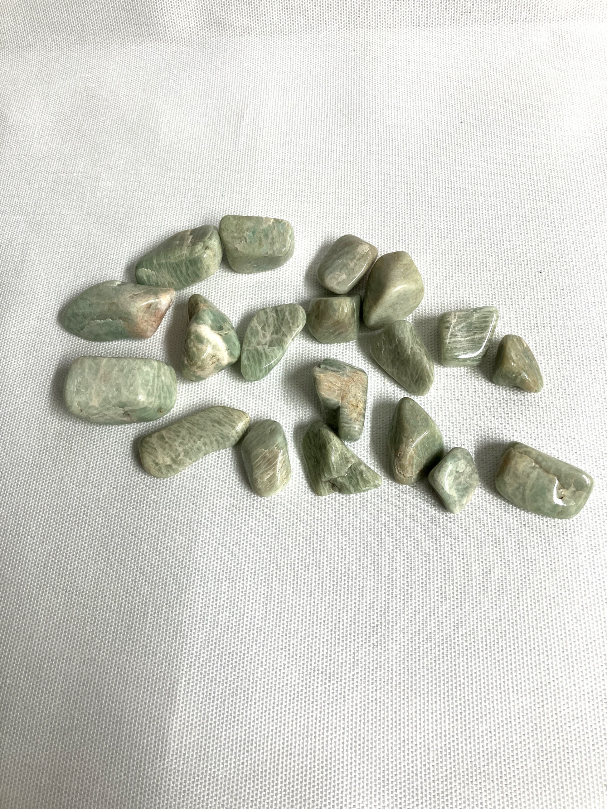 Front view of Amazonite Crystals  on a white fabric background
