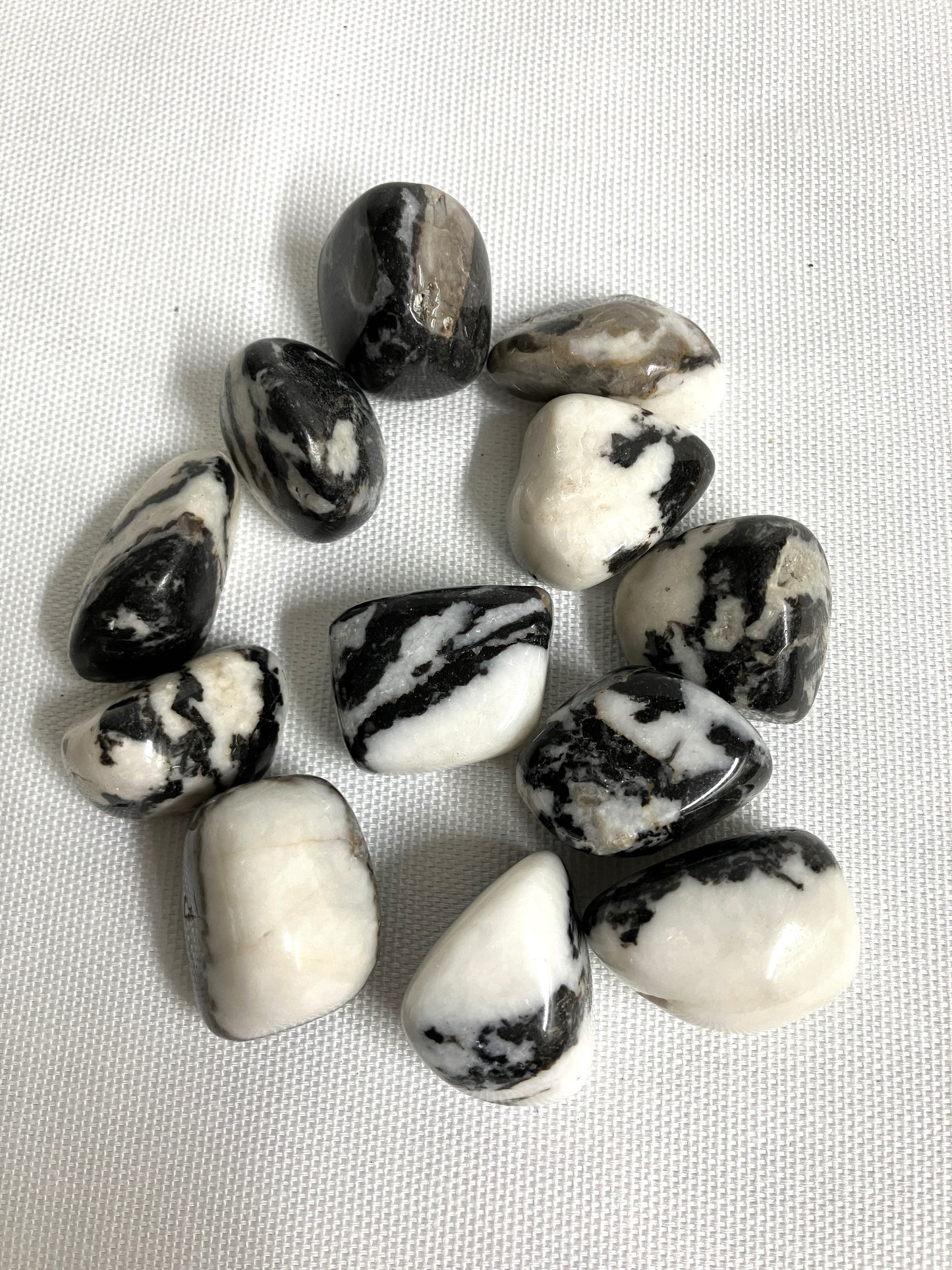 Back view of Black Zebra Jasper Crystals on a textured white surface