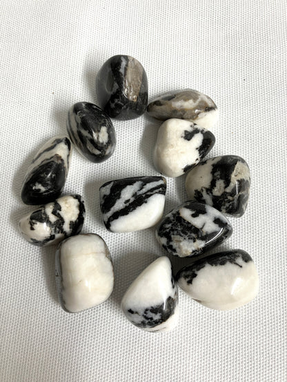 Back view of Black Zebra Jasper Crystals on a textured white surface