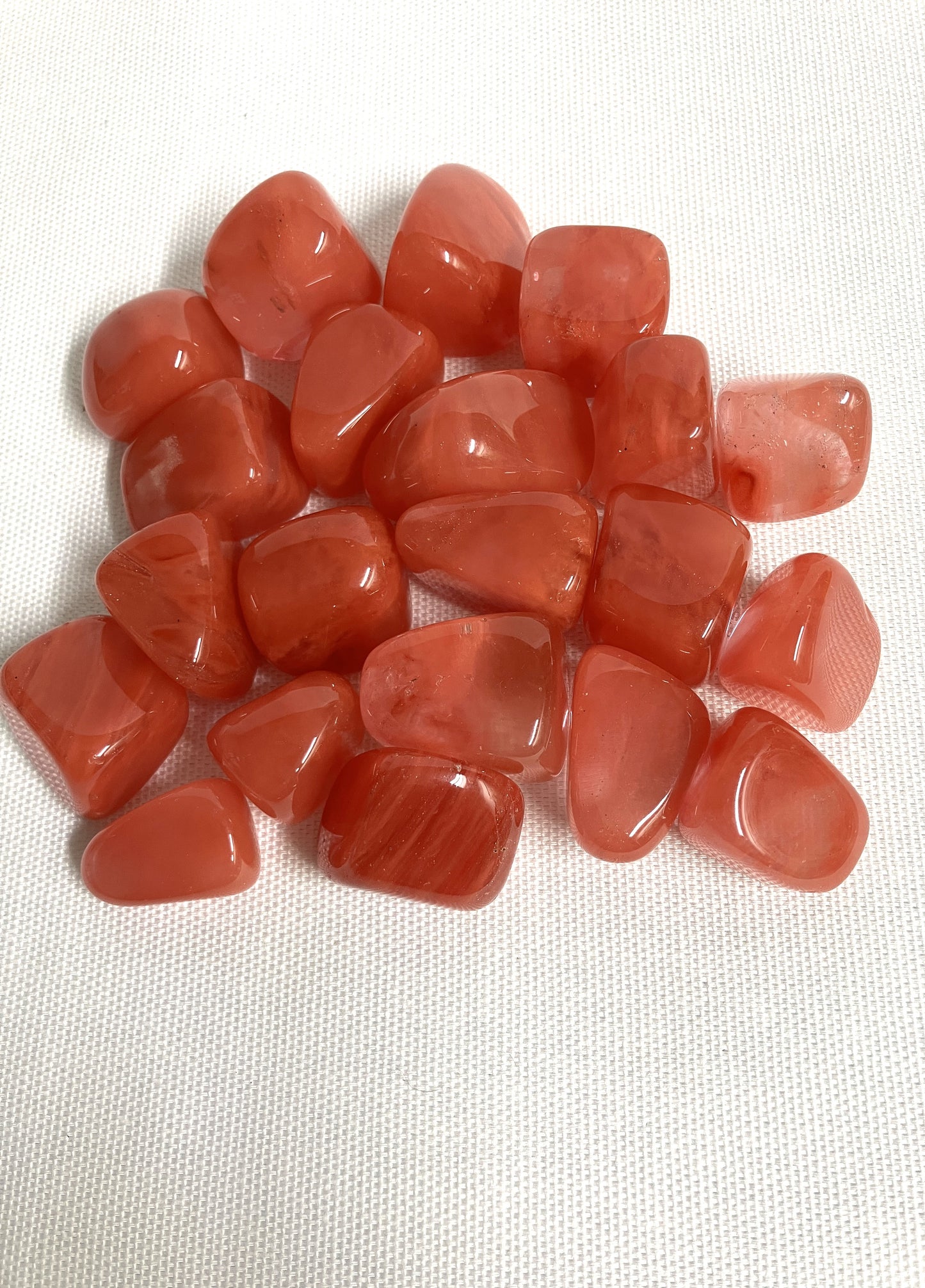Collection of Cherry Quartz Crystals on a white fabric background