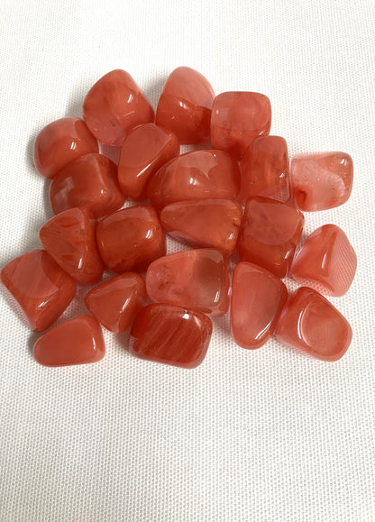 Collection of Cherry Quartz Crystals on a white fabric background