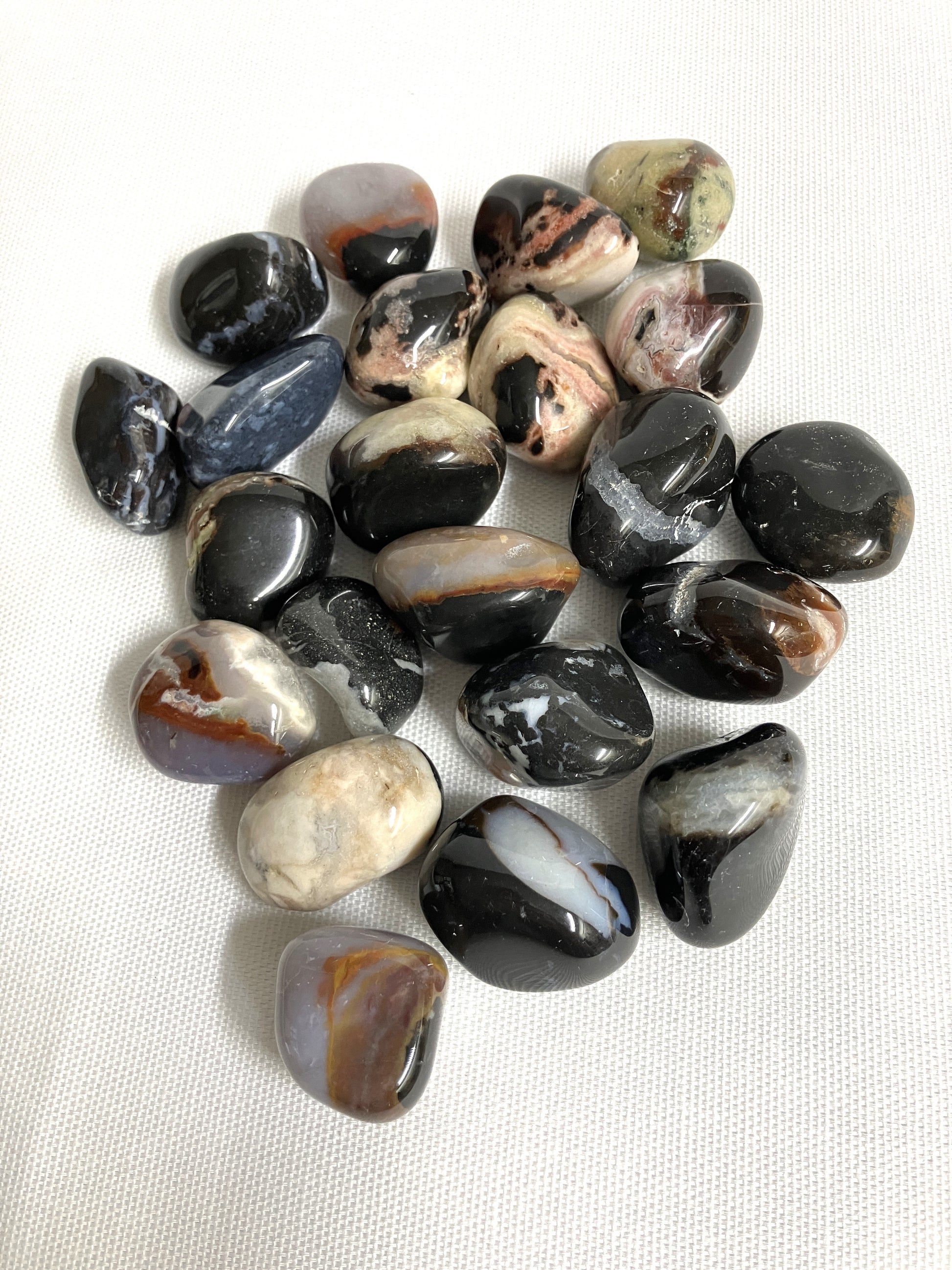 Back view of Black Sardonyx Crystals on a white fabric background