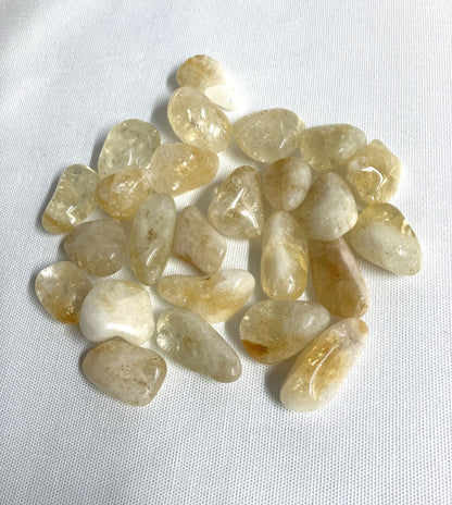 Citrine Tumbled Crystals showing front side on a white fabric background