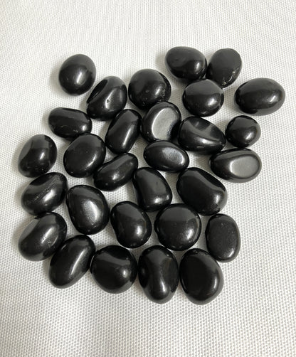 Back view of Shungite Crystals  on a light gray background