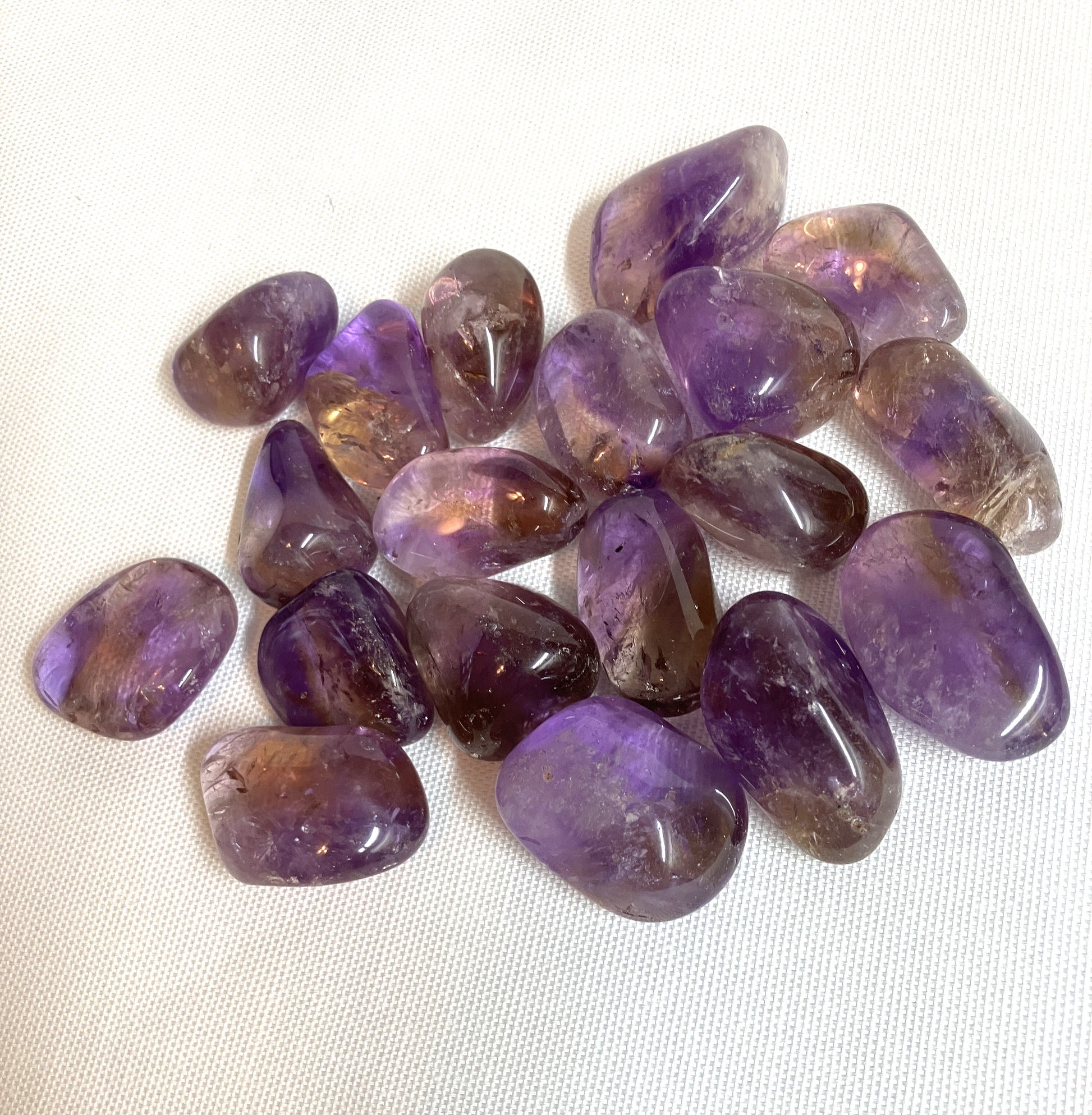 Ametrine Tumbled  Crystals showing another view on a white background