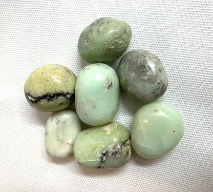 Another view of Green Chrysoprase Crystals on a white fabric background