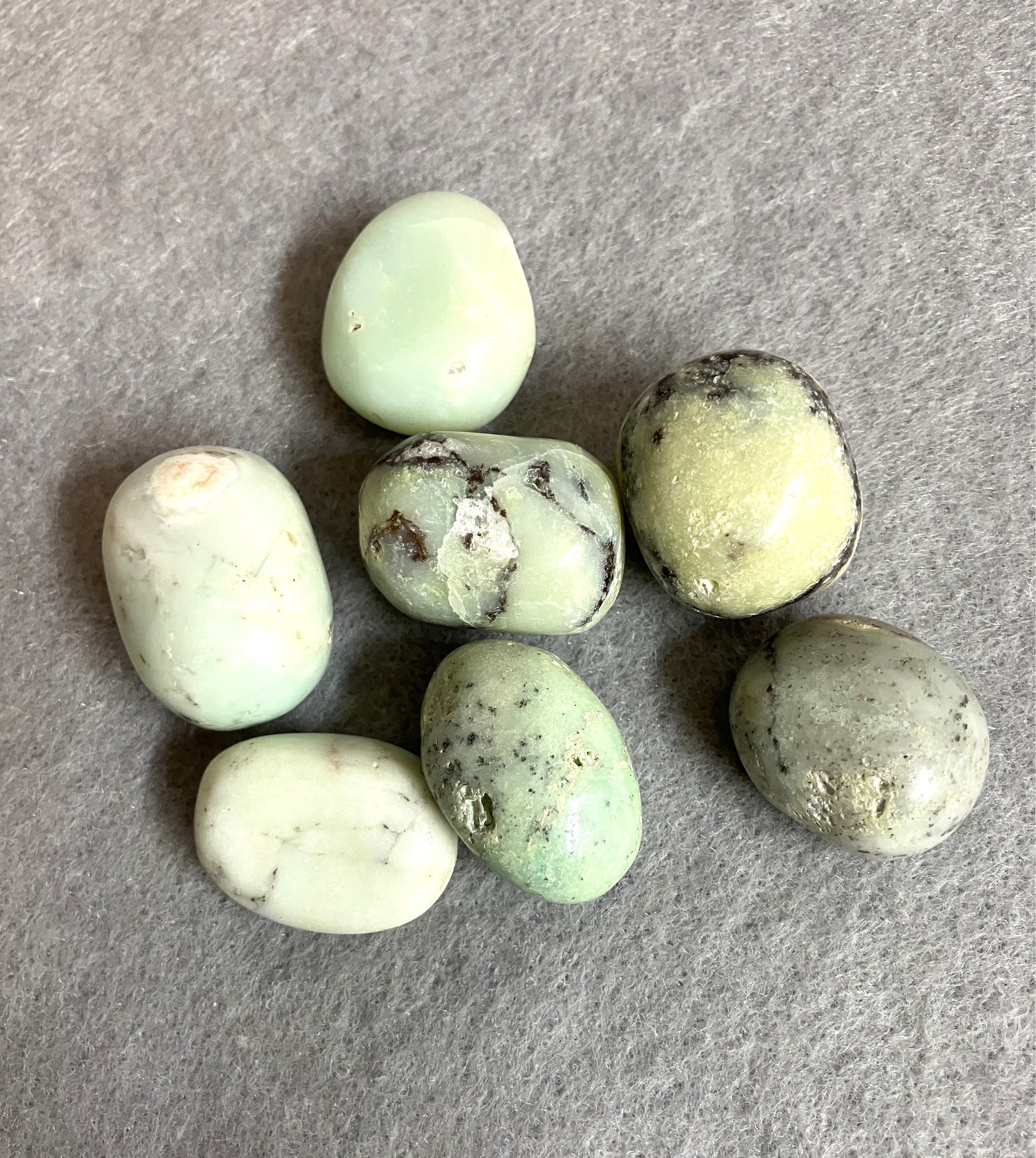 Green Chrysoprase Crystals on a gray surface