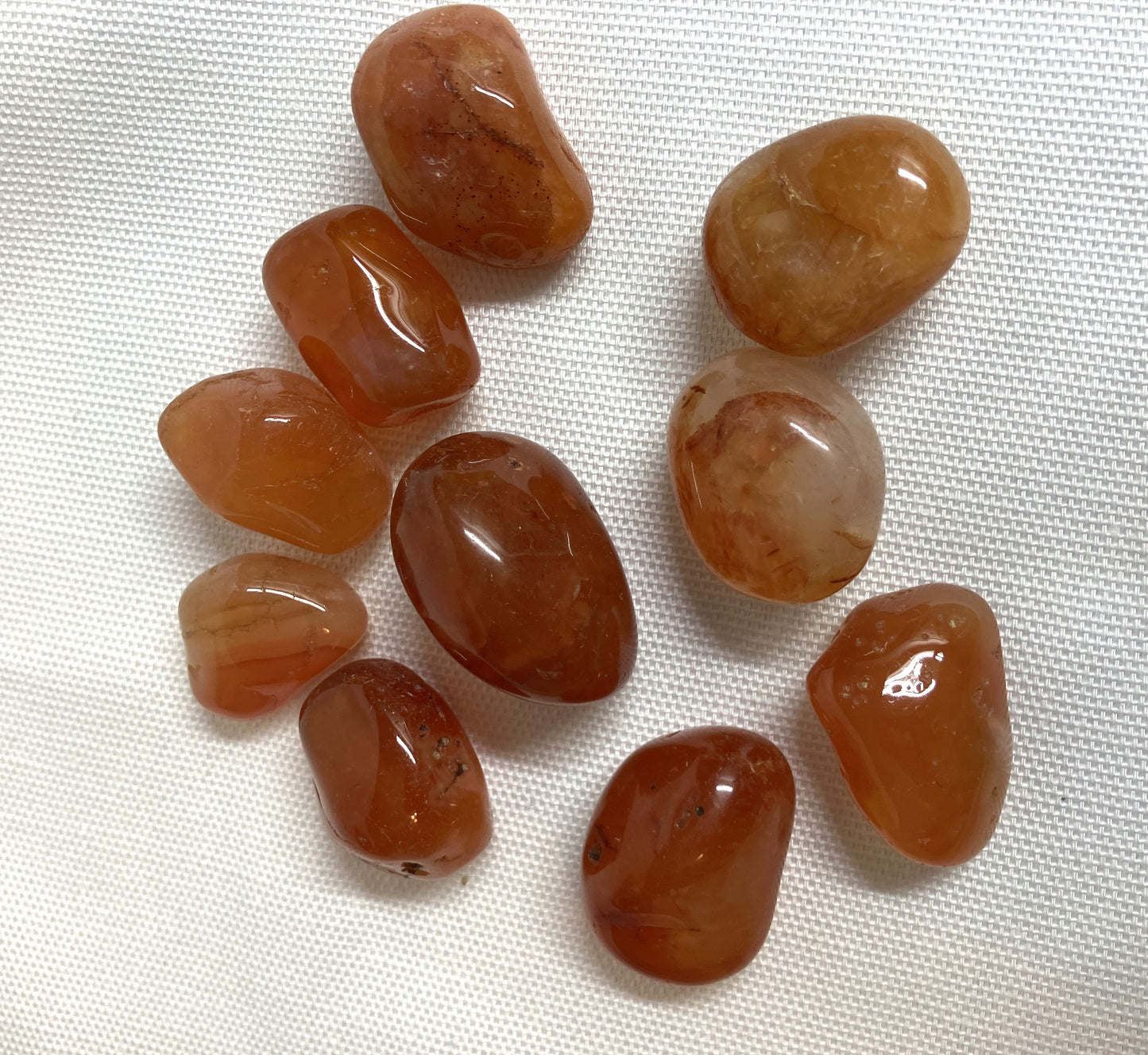 Carnelian Crystals on a white fabric background