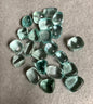 Group of Blue Obsidian Crystal on a gray surface