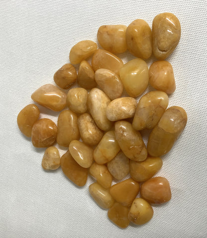 Closeup view of Apricot Quartz Crystals on a white fabric background