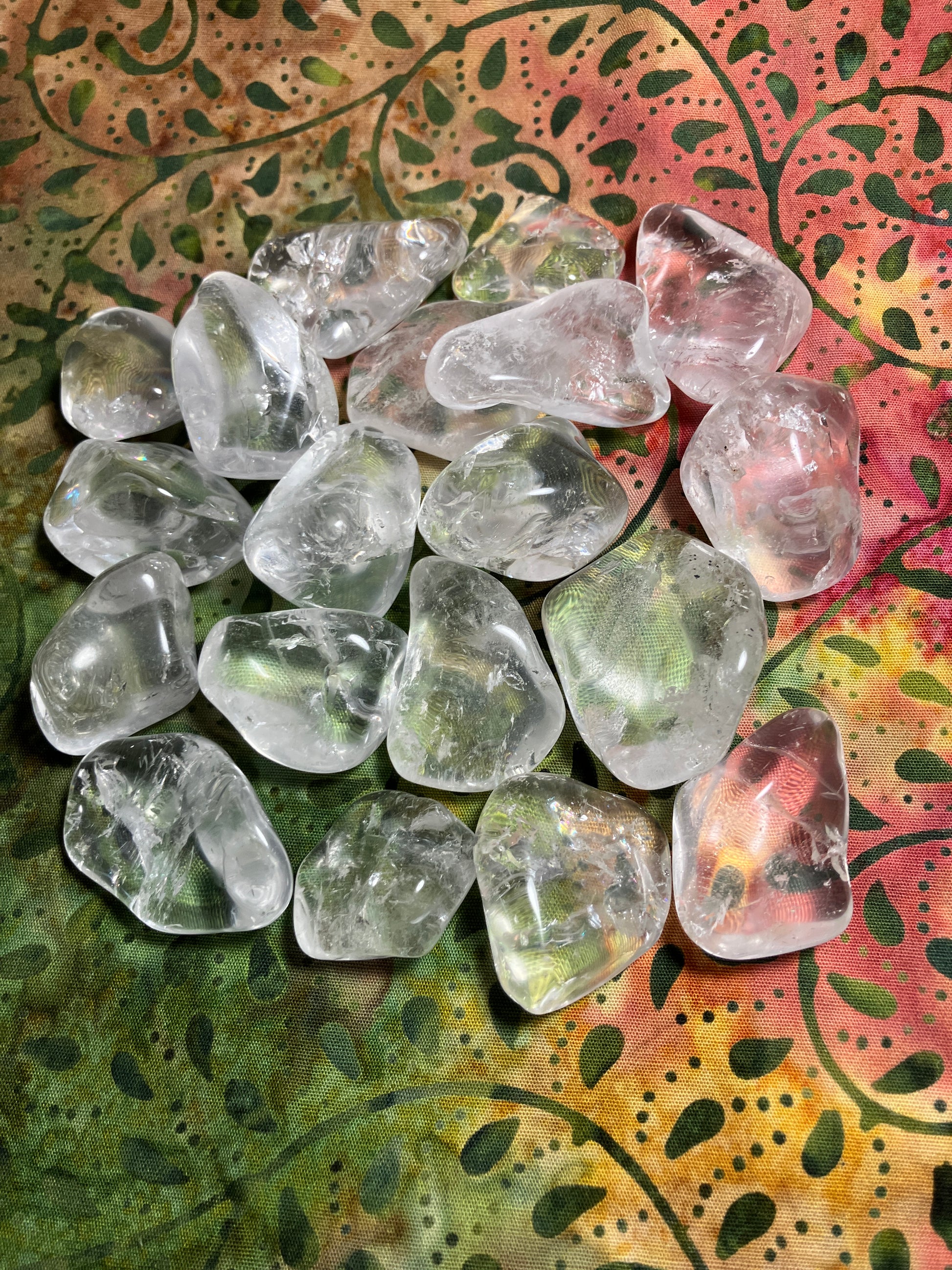 Tumbled Clear Crystals Quartz on a colorful patterned fabric