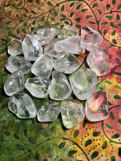 Tumbled Clear Crystals Quartz on a colorful patterned fabric