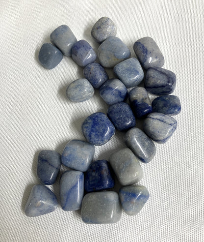Collection of Dumortierite Crystals showing the assorted veining on a light fabric background