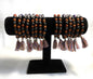 Chakra Stone Stretch Bracelet w/ Lava and Rudraksha Seeds on a black stand against a white background