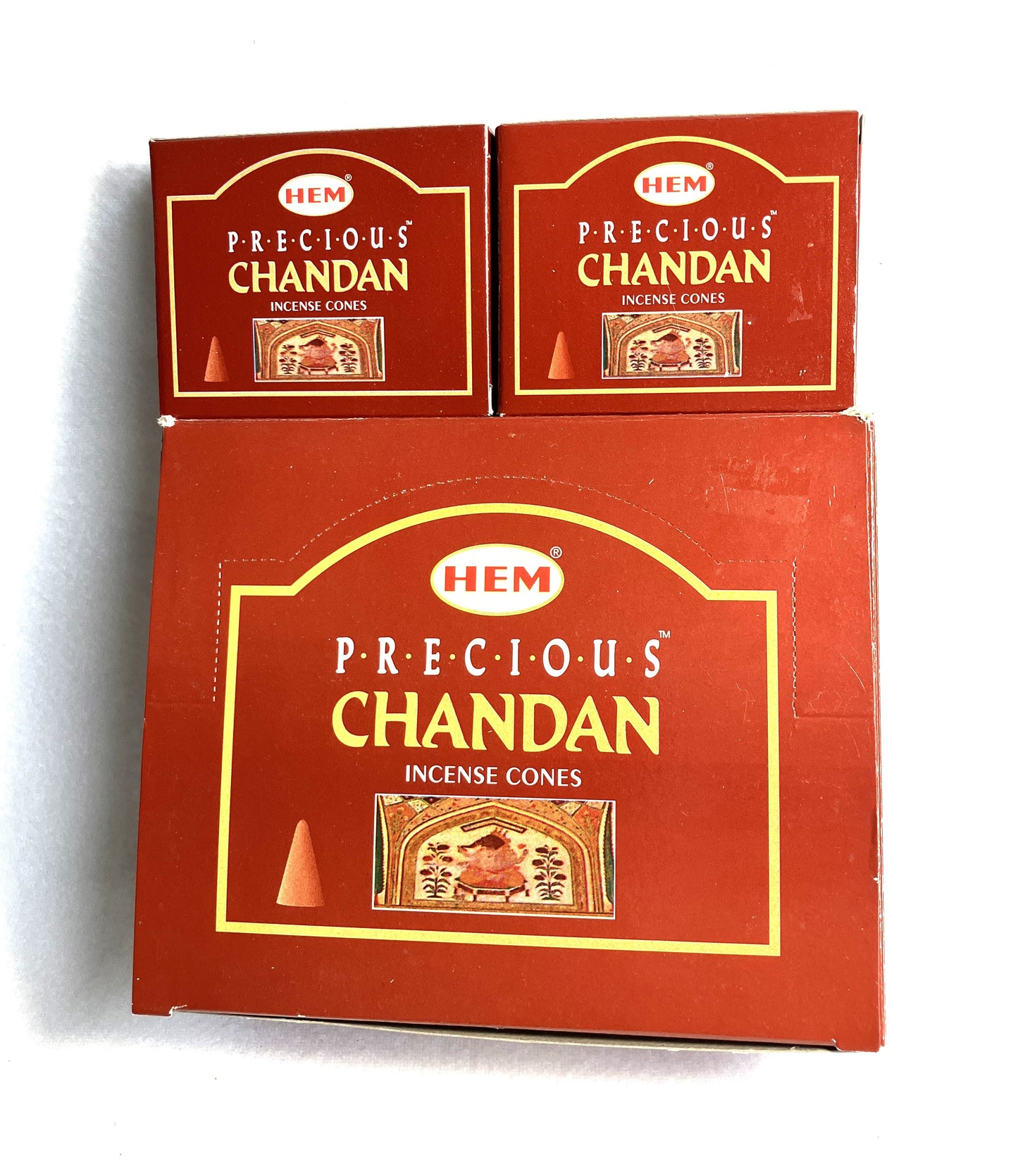 Master carton and Two boxes of HEM Precious Chandan incense cones shown on a white background