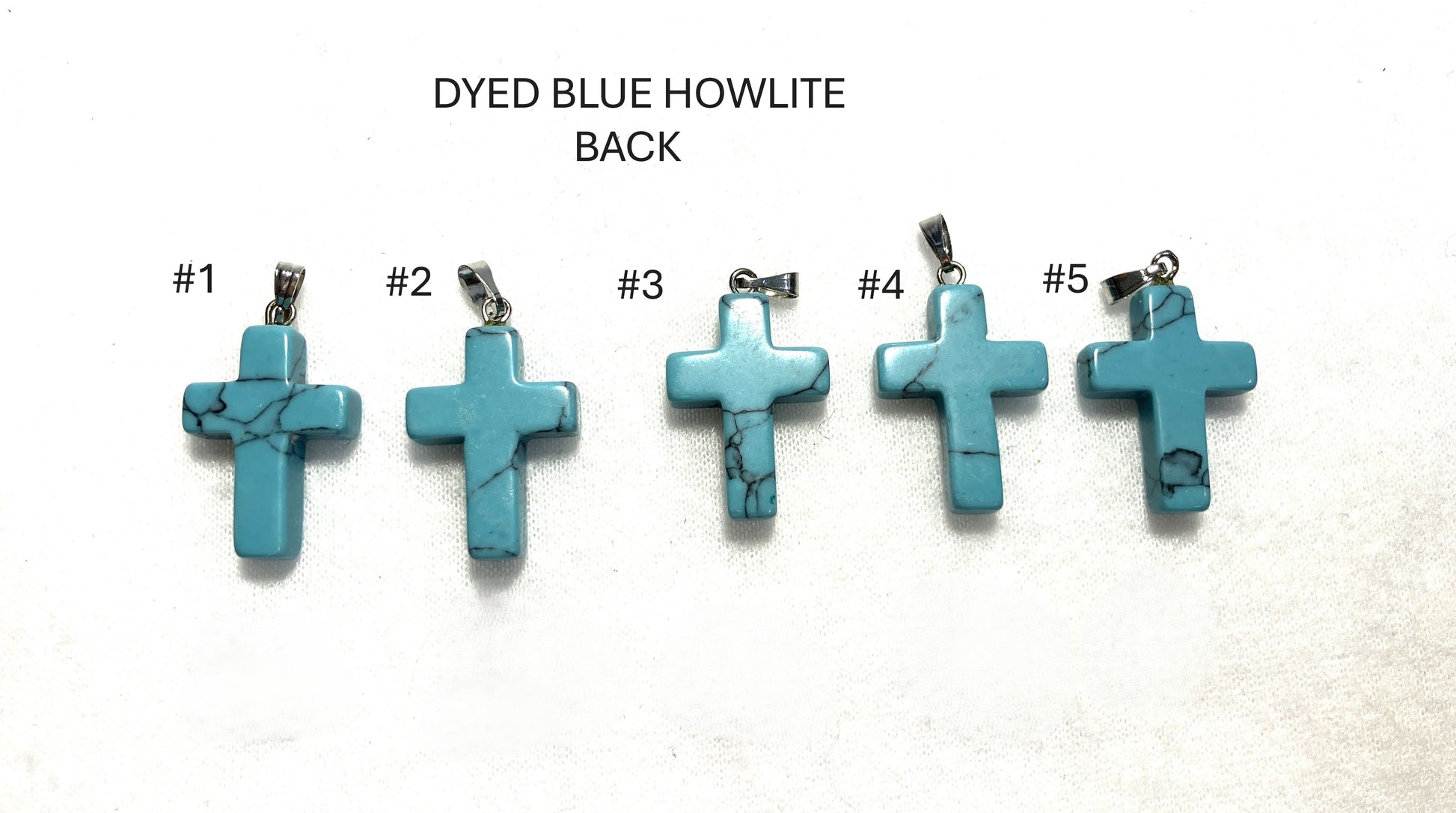 Five Dyed Blue Howlite Cross pendants labeled #1 to #5 on a white background with text 'DYED BLUE HOWLITE BACK'.