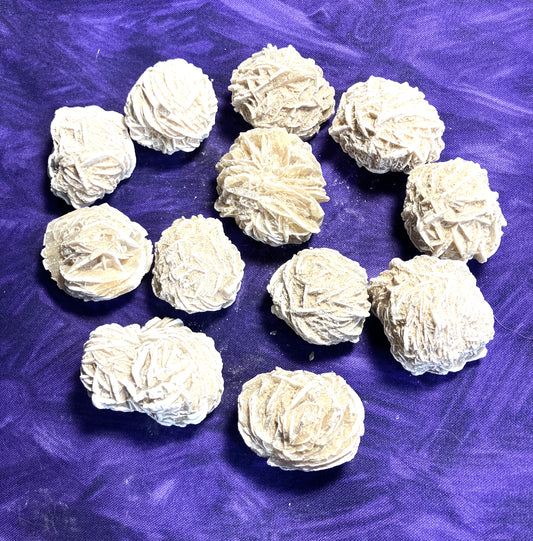 Desert Rose Selenite grouping on a purple background