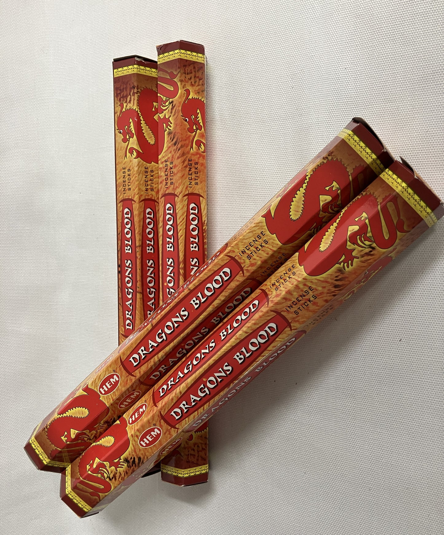 Packages of 'Dragon's Blood' incense sticks on a light gray background