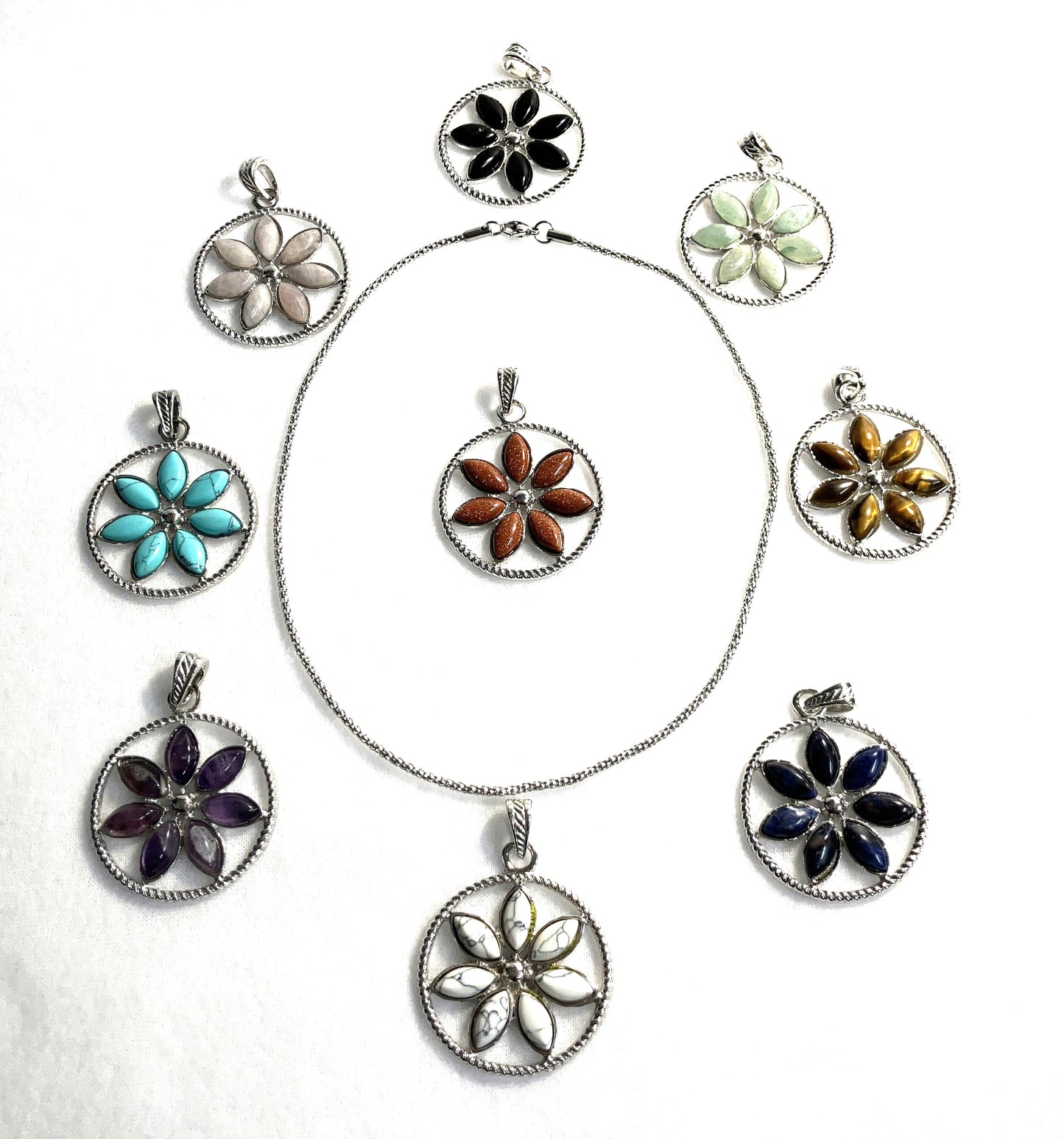 Group of floral pendant necklaces on a white background