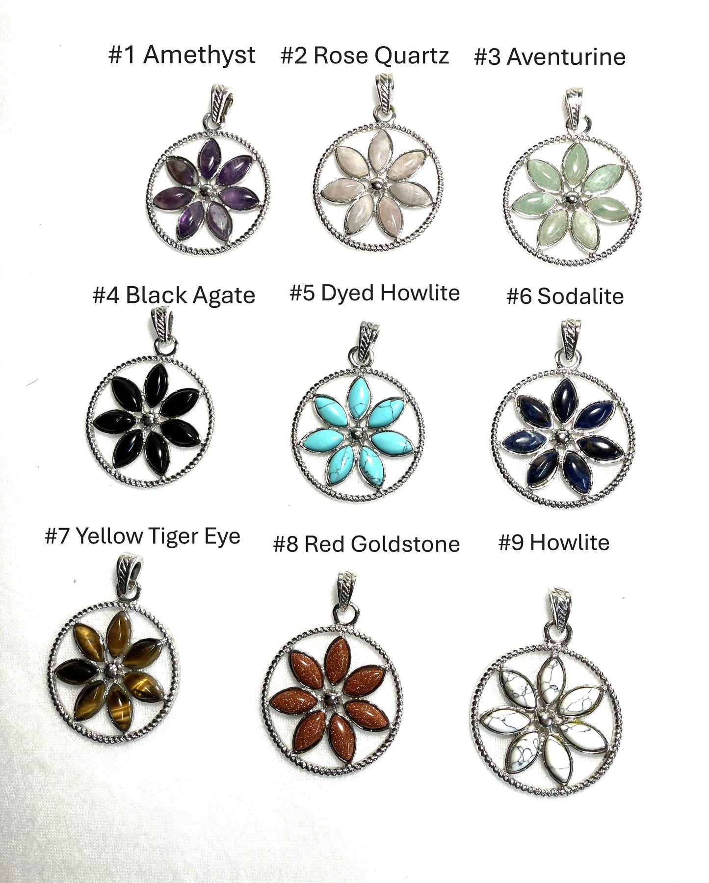 Collection of flower-shaped pendants with colored stones on a white background