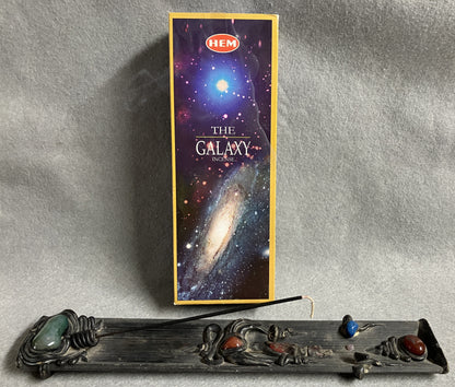 Hem  'The Galaxy' incense box shown with an incense burner on a gray background
