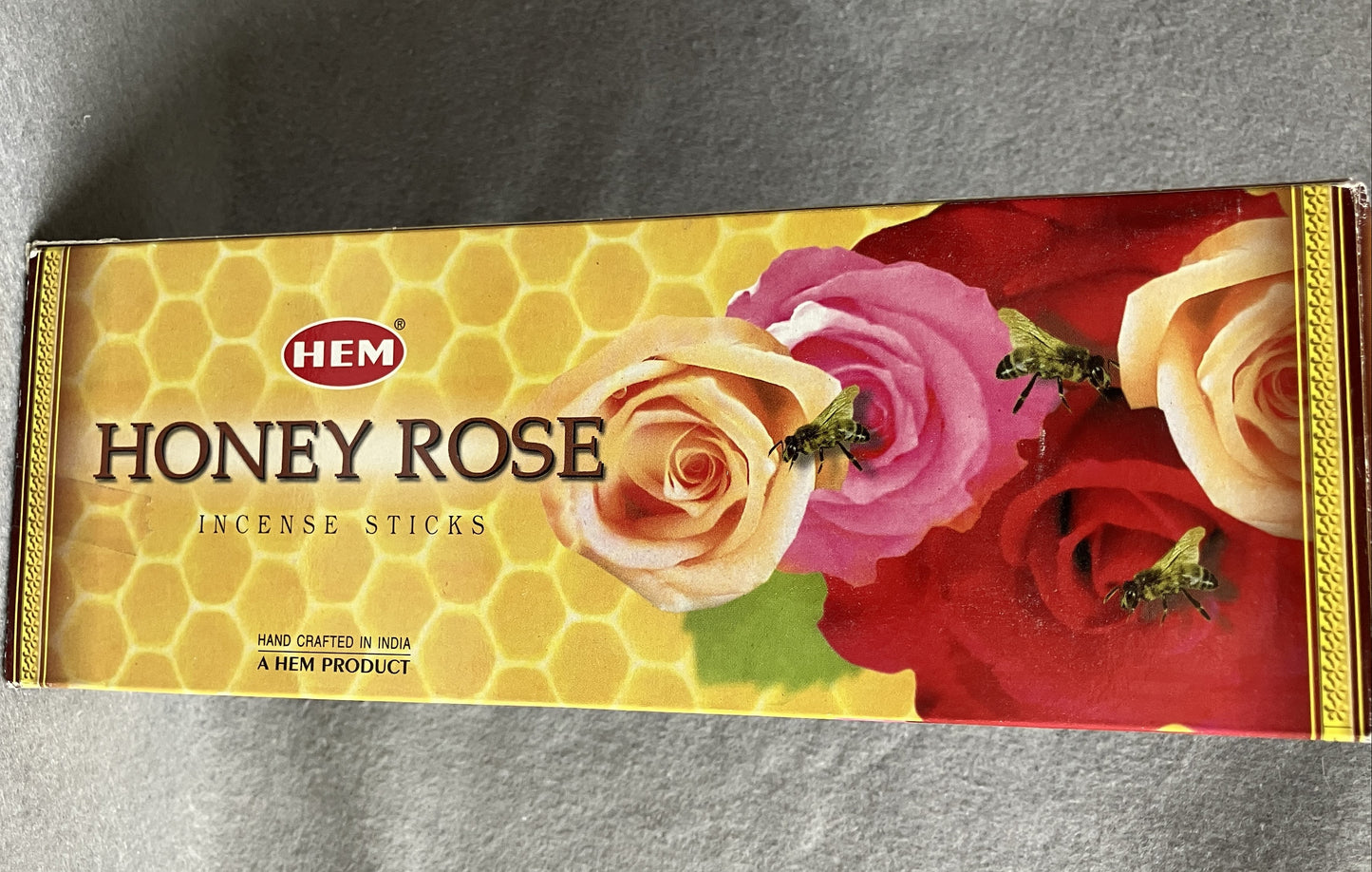 Honey Rose incense sticks packaging with roses and text on a gray background