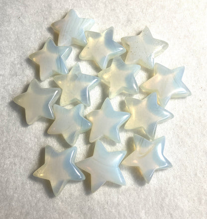 Group of Opalite Stars shown on a cream background showing the shine