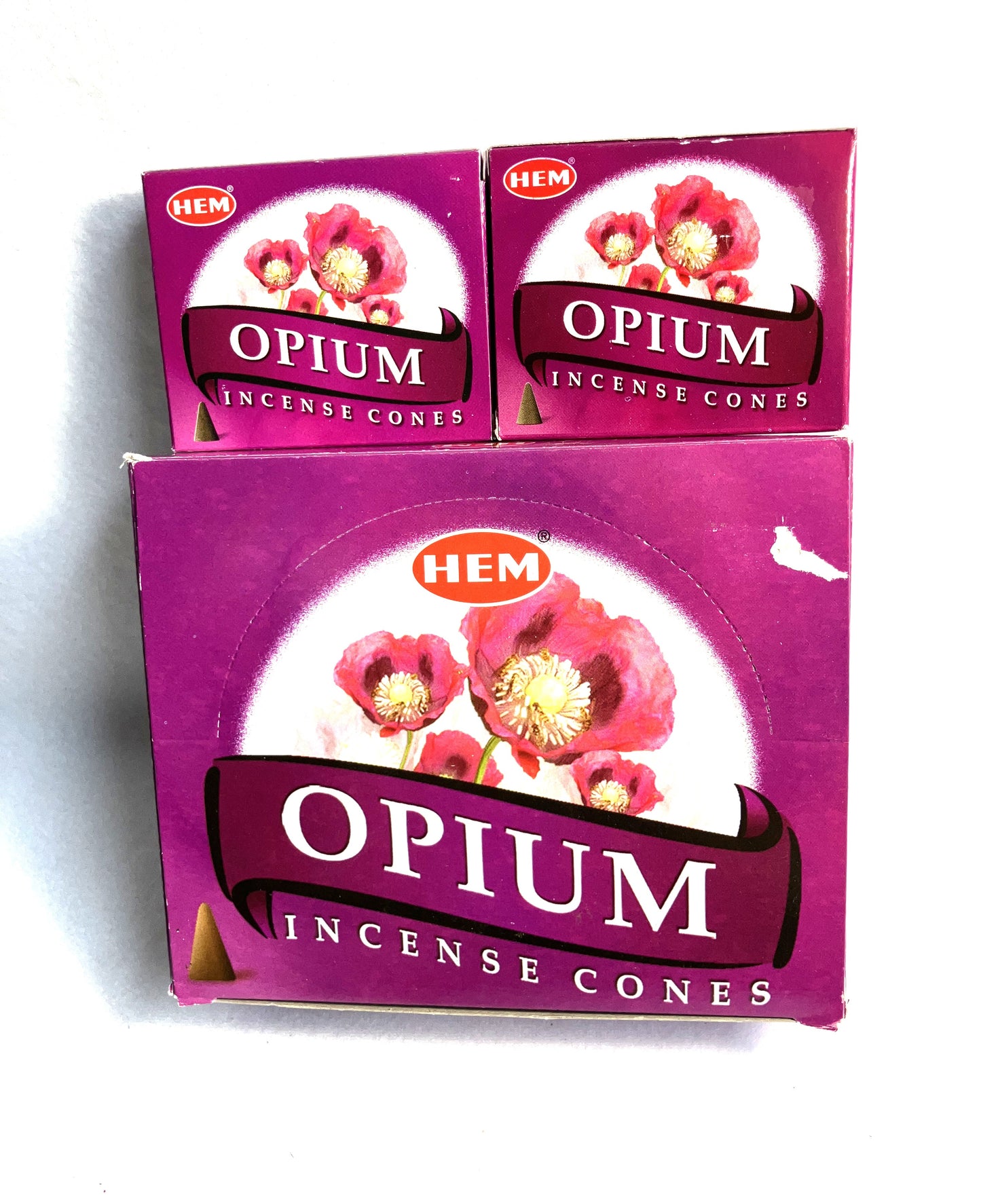 Master carton and two boxes of HEM Opium Incense Cones shown on a white background