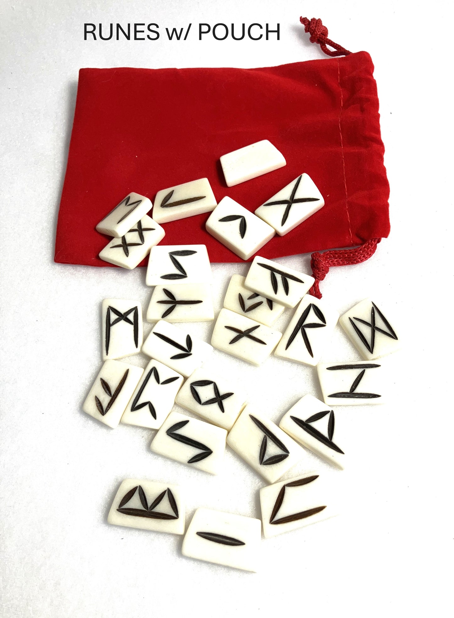 Set of bone runes with a red pouch shown on a white background