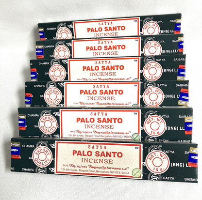 Multiple boxes of Satya Palo Santo Incense stacked on a white background