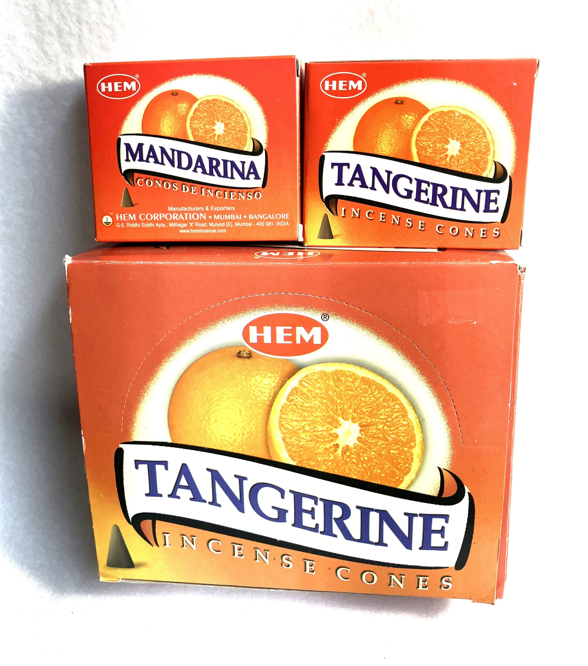 Master carton and two boxes of HEM Tangerine incense cones shown on a white background