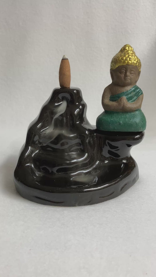 Backflow Buddha incense burner showing the smoke cascading down the front with the buddha statue on the right side
