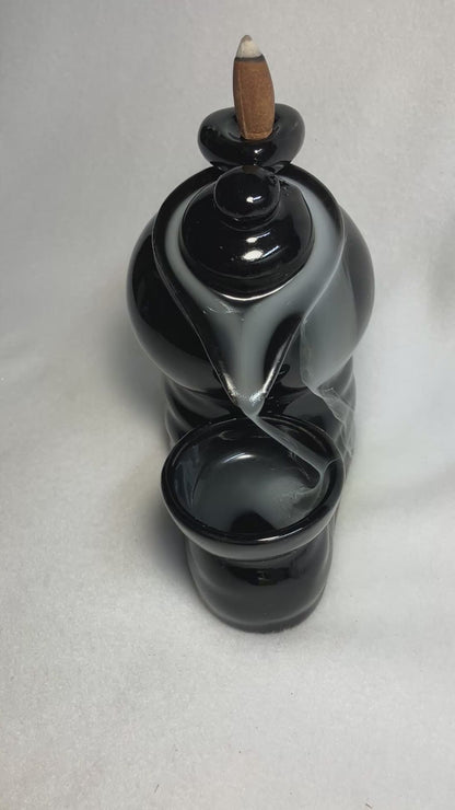 Backflow Tea Pot incense burner shown with cascading smoke. 