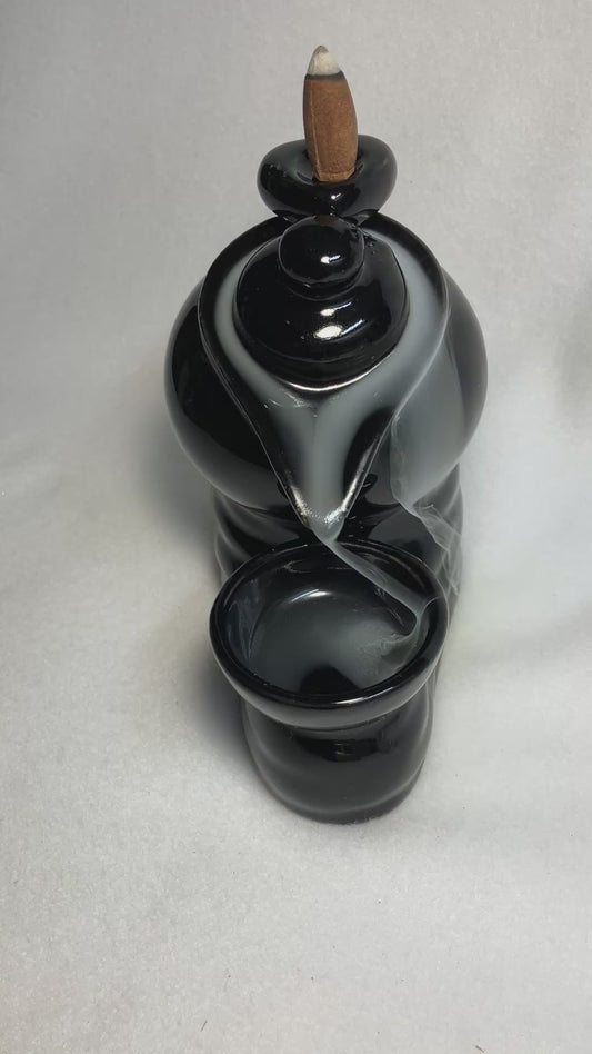 Backflow Tea Pot incense burner shown with cascading smoke. 
