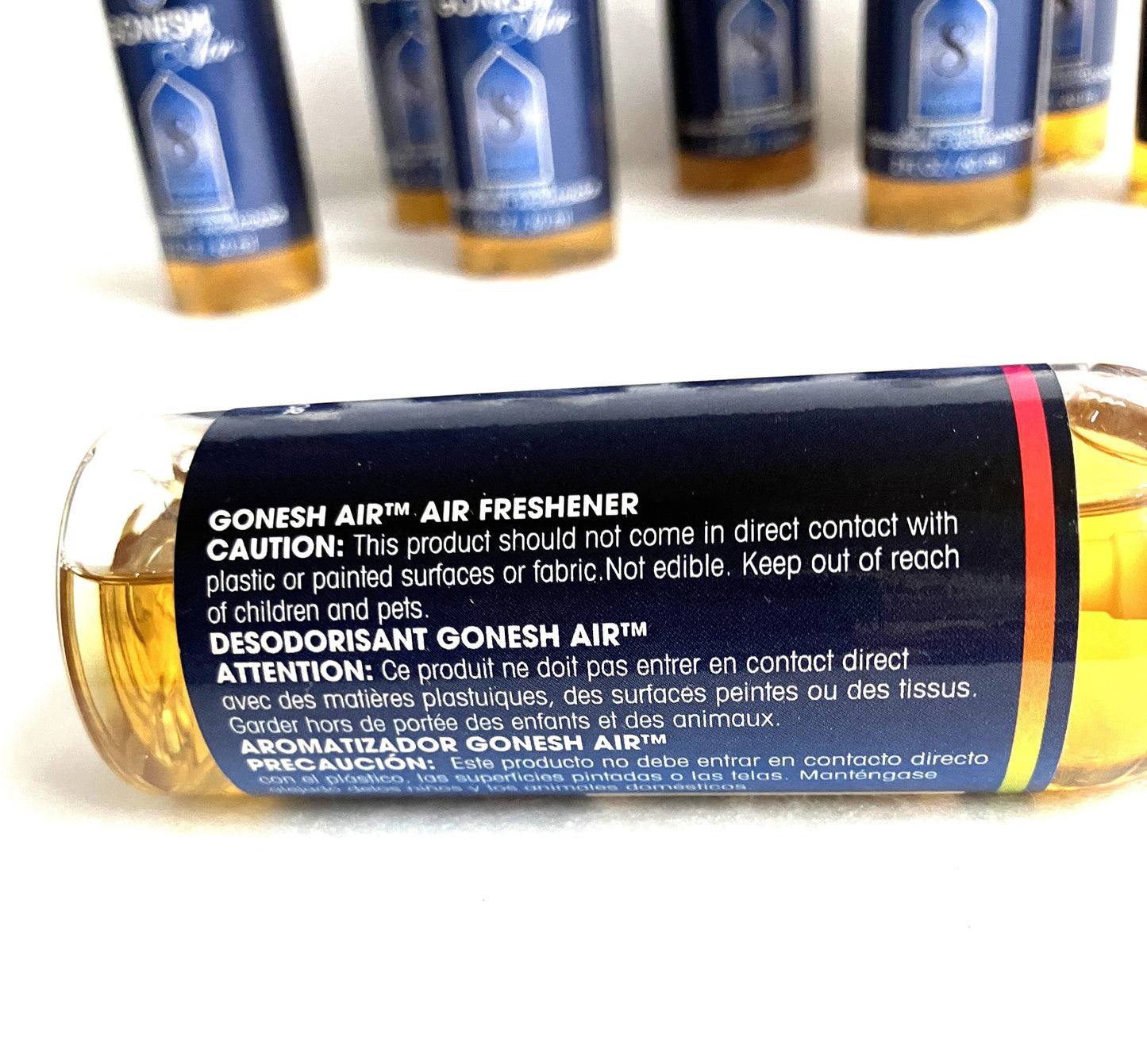 Close up of Gonesh Air air freshener bottle with label on a white background