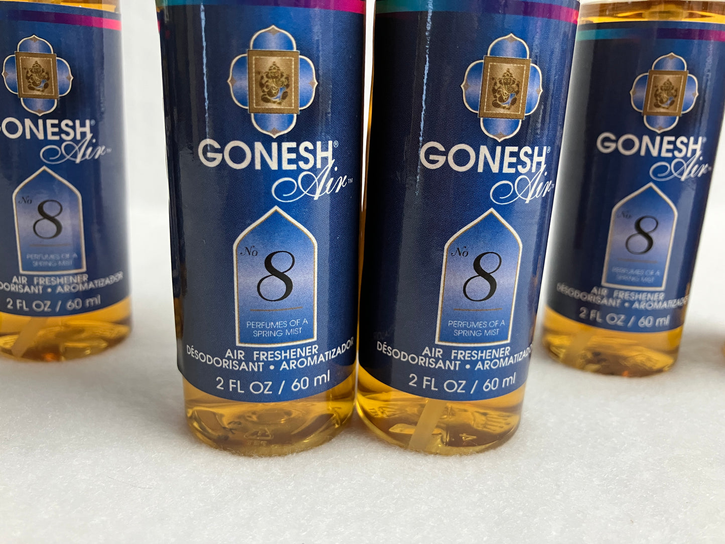 Four bottles of Gonesh Air No. 8 air freshener on a white background